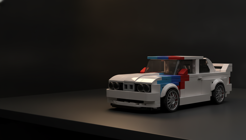 White brick-built BMW M3 E30 in racing livery on a dark desk