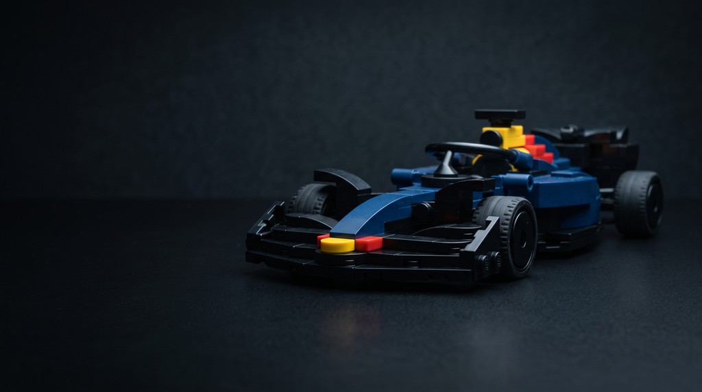 Blue brick-built Formula 1 single-seater model on a dark desk