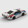 White with blue and red accents BMW M1 brick model rear three quarter view