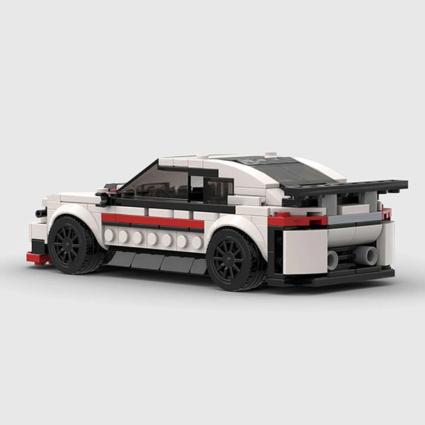 White with black and red accents BMW M240i brick model rear three quarter view
