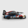 White, black, red, and blue motorsport livery BMW M4 GT3 brick model side profile view