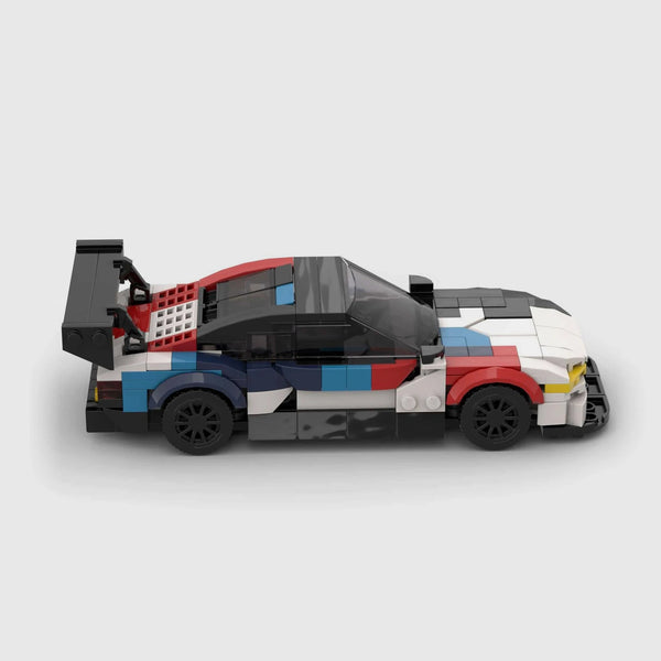 White, black, red, and blue motorsport livery BMW M4 GT3 brick model side profile view