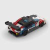 White, black, red, and blue motorsport livery BMW M4 GT3 brick model rear three quarter view