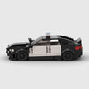Black and white BMW M5 F90 brick model side profile view