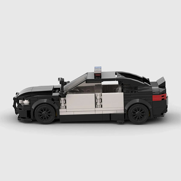 Black and white BMW M5 F90 brick model side profile view