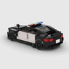 Black and white BMW M5 F90 brick model rear three quarter view