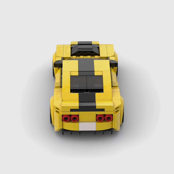 Bright yellow with black racing stripes Chevrolet Camaro brick model rear view