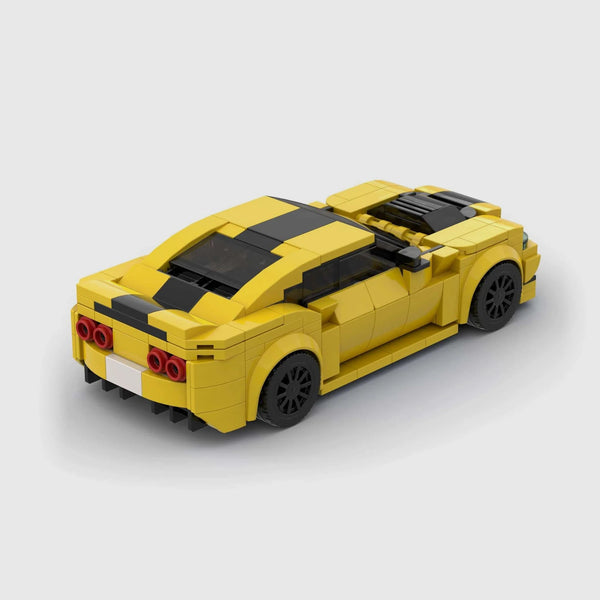 Bright yellow with black racing stripes Chevrolet Camaro brick model rear three quarter view