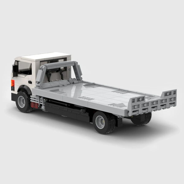 White cab with grey flatbed and black chassis brick model rear three quarter view