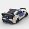 White and blue Ford Mustang Police Edition brick model high rear three quarter view