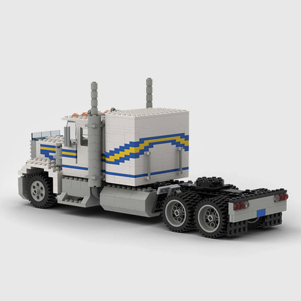 White with blue and yellow stripes Peterbilt 379 brick model rear three quarter view