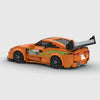 Orange with green accents Toyota Supra brick model rear three quarter view