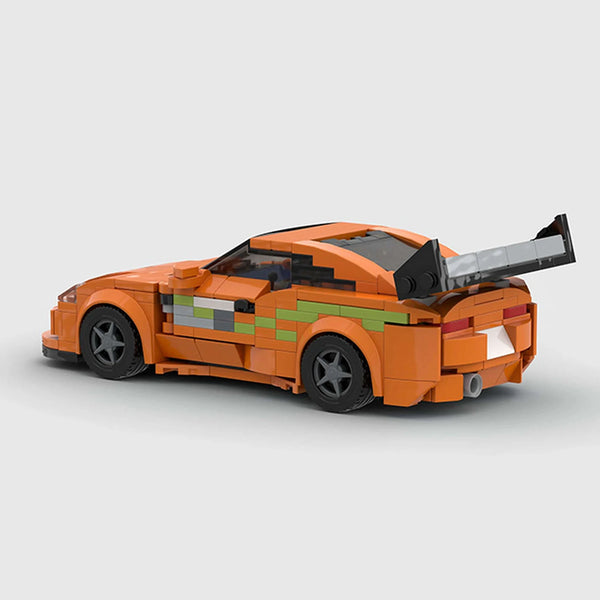Orange with green accents Toyota Supra brick model rear three quarter view